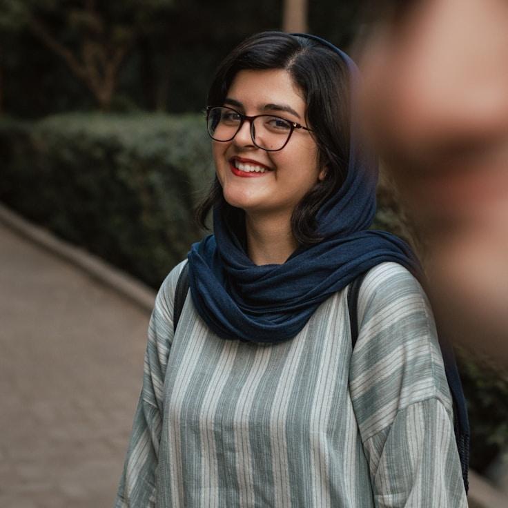 Avery Chen, Lead Design Curator at Nimbus Lunar Stellar, reviewing corporate floral arrangements